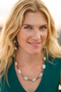 A headshot of Anya Kamenetz, smiling and wearing a greenish top.