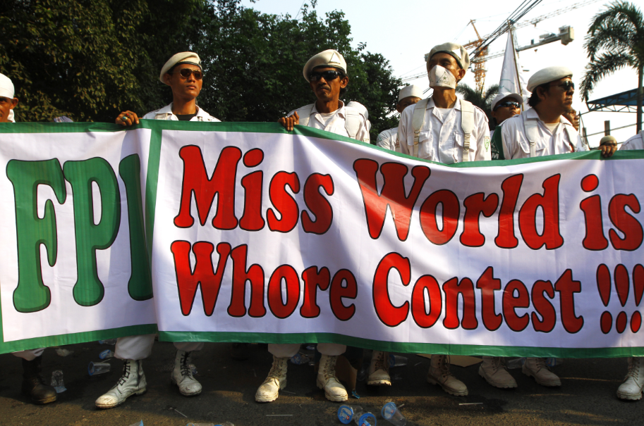 Muslim demonstrators hold posters rejecting the Miss World 2013 in Jakarta. Photo by dharma wijayanto, Copyright@Demotix (9/3/2013)  