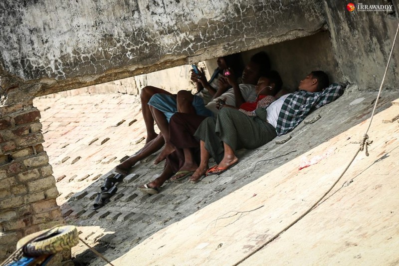 Yangon residents find a shade to rest. Photo by Hein Htet / The Irrawaddy