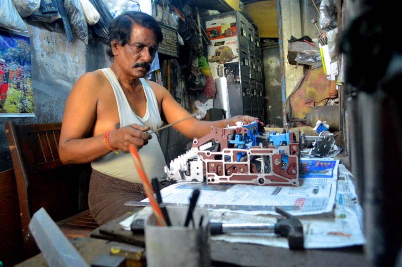 In a small shop on 35th Street, Mya Win, 62, repairs a broken typewriter purchased from a government auction. He has been working on the machines for 40 years. (Photo and caption: Sally Kantar / The Irrawaddy)