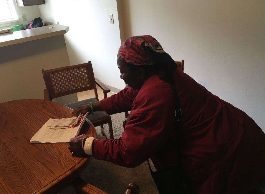 Mme Yulina Bilombele, 80 ans, rassemble son avis d'éviction et ses reçus du loyer pour M. Floribert Mubalama pour qu'il les lui traduise parce qu'elle ne parle pas anglais. Les deux sont des réfugiés de la République démocratique du Congo vivant dans la zone métropolitaine de Seattle. Crédit: Isabel Vázquez / NextGenRadio