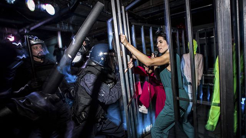 Punk group Pussy Riot perform in a cage on stage at Dismaland. Photo by Vianney Le Caer for Pussy Riot.