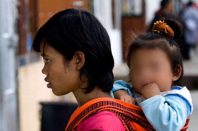 A mother and her child in Bhutan. Photo: Steve Evans / Flickr. CC 2.0. Edited by Kevin Rothrock.
