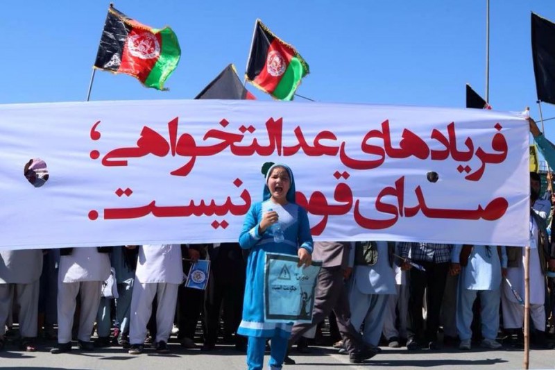 A Hazara girl standing in front of a march in a TUTAP demonstration. Shared via Republic of Silence Facebook page. 