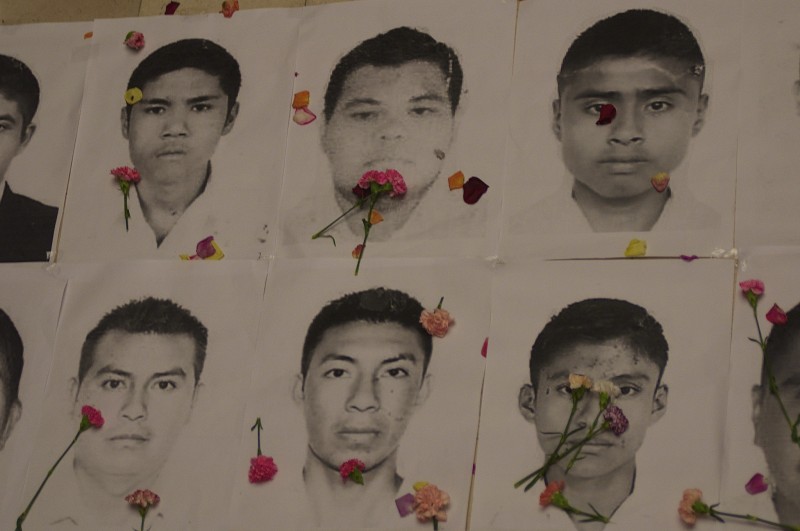 Portraits of missing Mexican students with carnations in a symbolic act in front of the Mexican Embassy in Bogota, Colombia on Nov. 7. Photo from Agencia Prensa Rural's Flickr account. CC BY-NC-ND 2.0