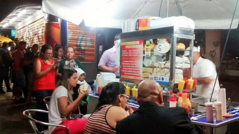 Enquanto comem, fregueses se divertem com bom humor do vendedor. Foto: Divulgação