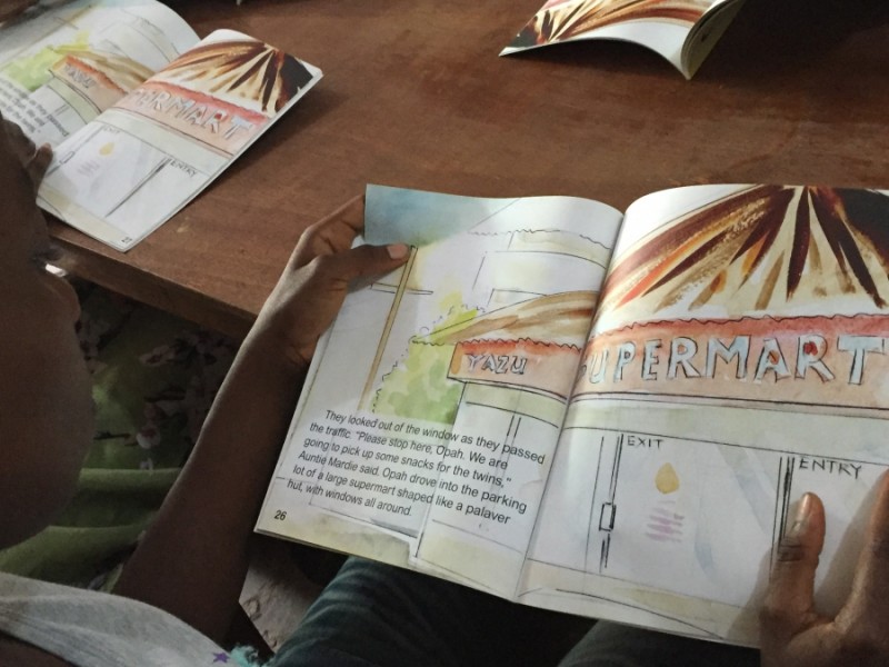 Children read "Gbagba," a book by Liberian author Robtel Neajai Pailey about corruption. Credit: Prue Clarke. Used with PRI's permission