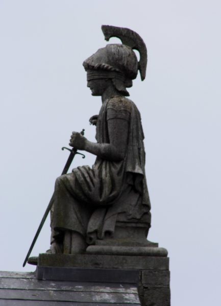 Blind justice - Statue on former court buildings, Caernarfon ( Creative Common License on Flickr, Siaron James)