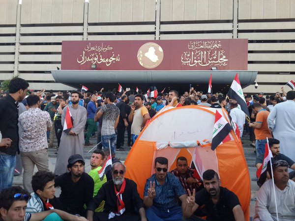Iraqi protestors outside the Parliament earlier today where they staged a sit-in before storming the building. Photo credit: @AlFayth (Twitter)