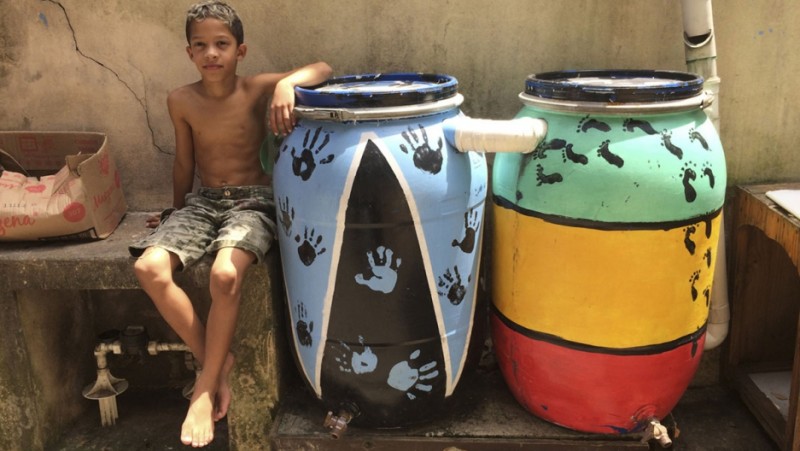 Two of about 50 rain barrels in the Vergueirinho favela in São Paolo, Brazil. Terezinha da Silva taught residents how to build the barrels to conserve water. Credit: Anne Bailey. Used with PRI's permission