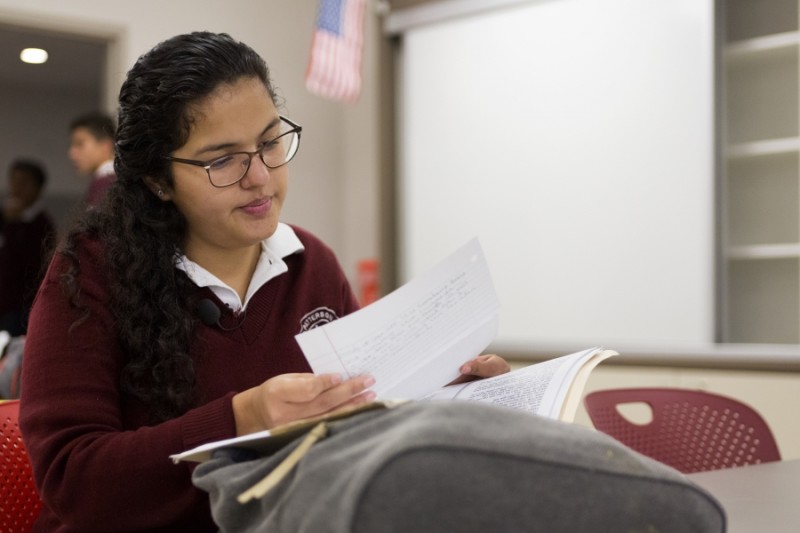 After breakfast, Arlet sits in her first period class, and looks over class materials. Credit: Miguel Gutierrez Jr./KUT News. Used with permission.