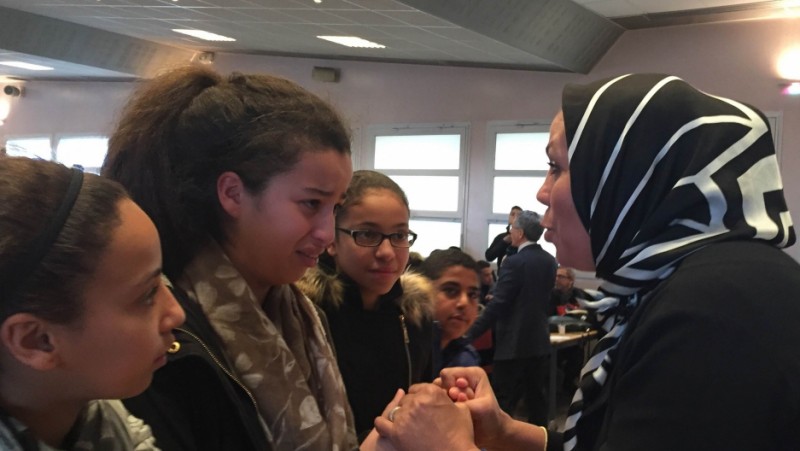 Latifa bin Ziaten (r) speaks with students about her son, Imad, who was murdered by Islamic extremist Mohamed Merah. At the end of her talk, students hug her. One girl says Latifah reminds her of her own mother. Credit: Marine Olivesi. Used with PRI's permission.