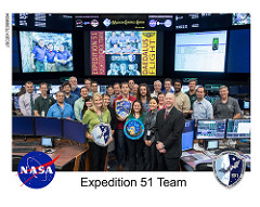 Hanging the Expedition 51 patch at NASA mission control