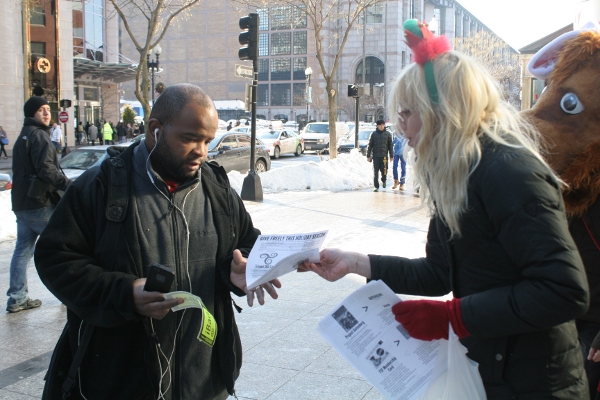 An activist sharing the Giving Guide at a Giveaway.