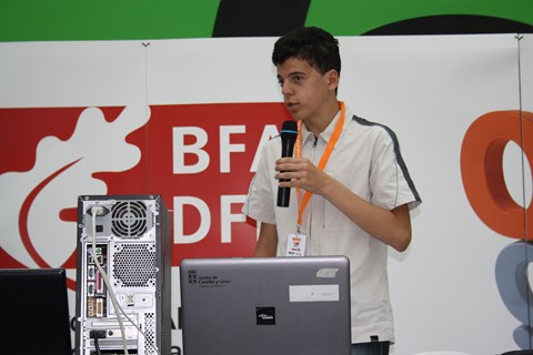 Intern standing at a podium speaking into a microphone