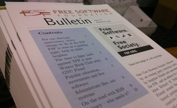 Picture of the Bulletin with boxes of envelopes in the background